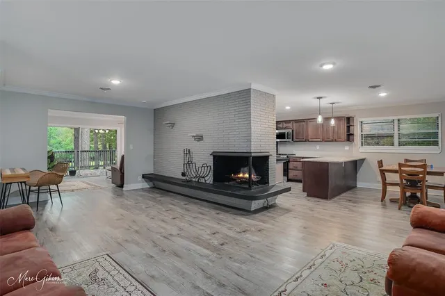 a living room with furniture a window and a fireplace