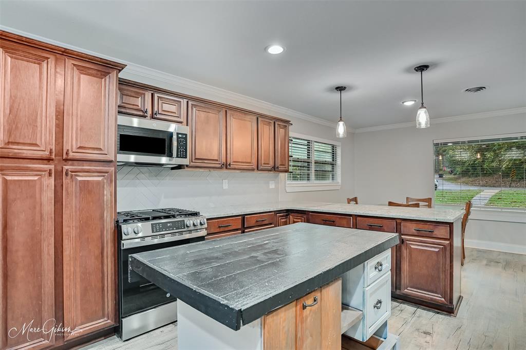 2912 Brookline Drive Shreveport, LA 71119 - Photo 7 of 27 a kitchen with stainless steel appliances a sink a stove a microwave cabinets and a window
