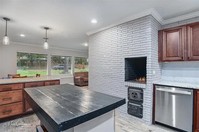 a kitchen with kitchen island a sink dining table and chairs