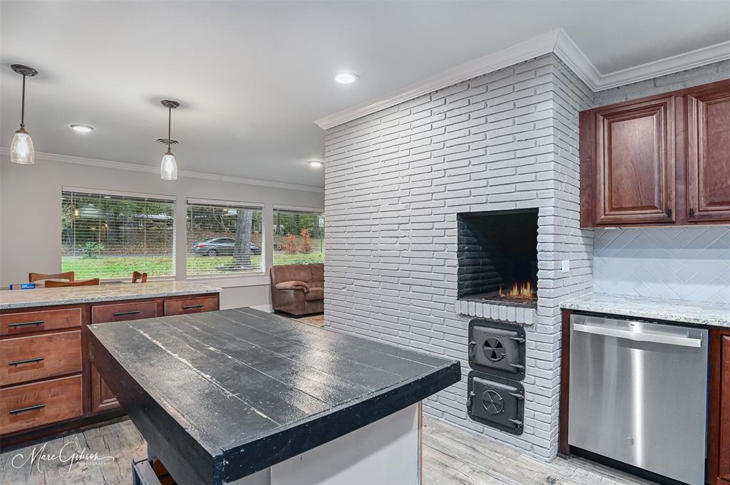 2912 Brookline Drive Shreveport, LA 71119 - Photo 8 of 27 a kitchen with kitchen island a sink dining table and chairs