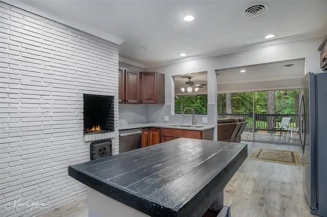 a kitchen with a table chairs microwave and refrigerator