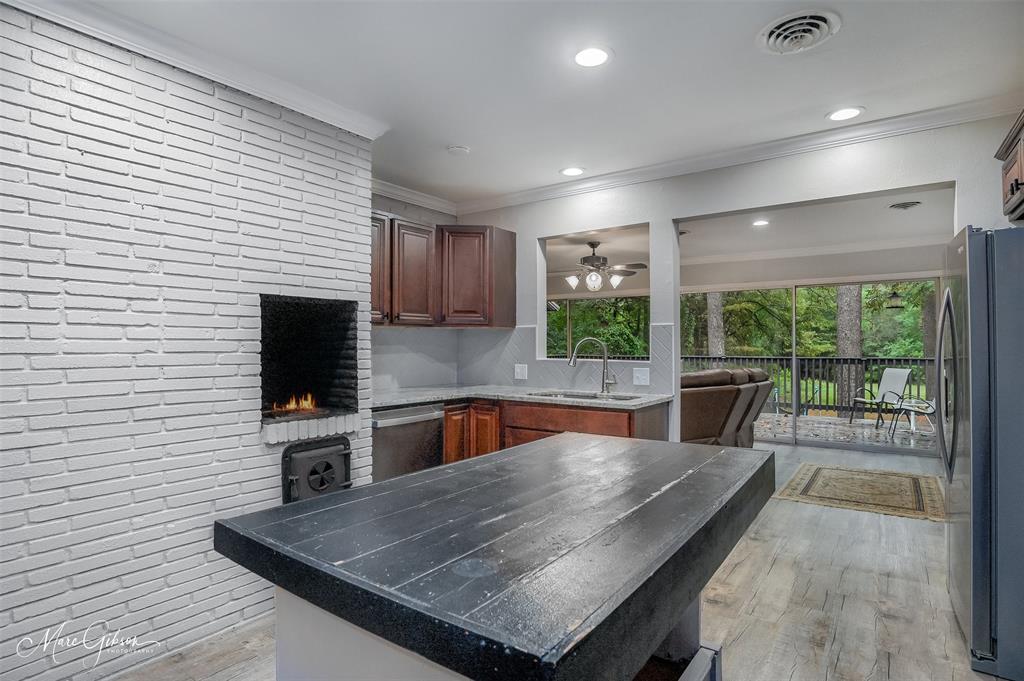 2912 Brookline Drive Shreveport, LA 71119 - Photo 9 of 27 a kitchen with a table chairs microwave and refrigerator