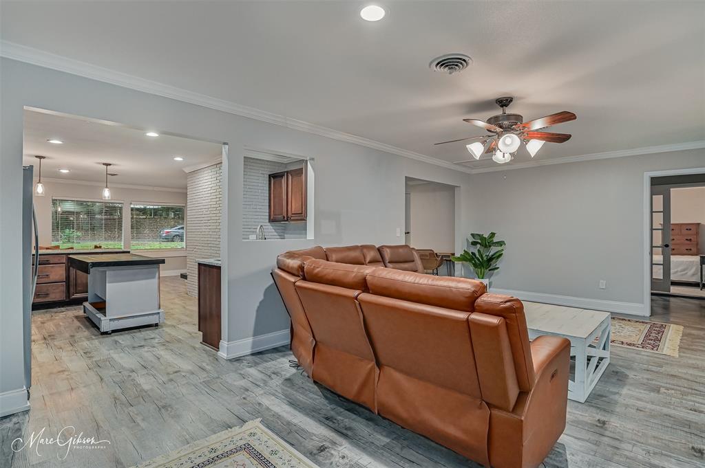 2912 Brookline Drive Shreveport, LA 71119 - Photo 10 of 27 a living room with furniture a fireplace and a chandelier