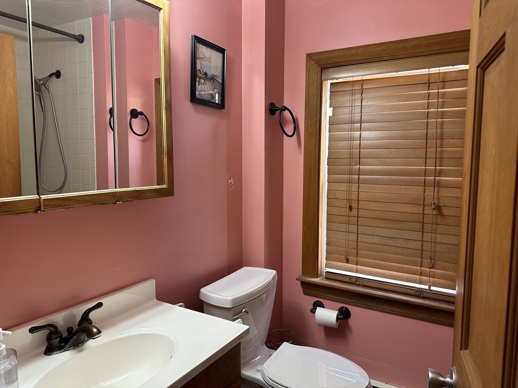 79 Wareham Street Middleboro, MA 02346 - Photo 18 of 27 a bathroom with a sink a toilet and shower curtain