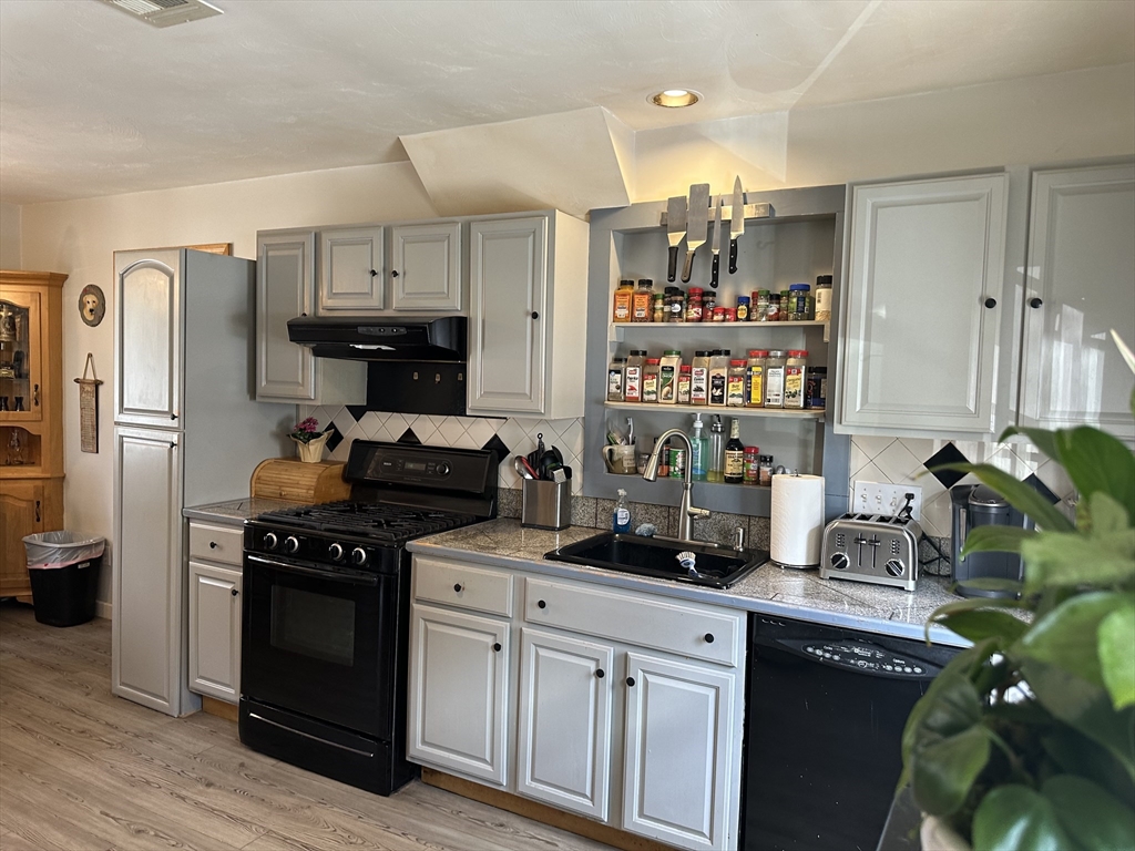 79 Wareham Street Middleboro, MA 02346 - Photo 4 of 27 a kitchen with stainless steel appliances a sink a stove a refrigerator cabinets and a dining table
