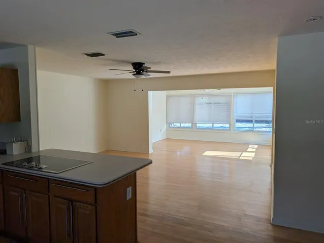 a view of a kitchen with a sink and a refrigerator