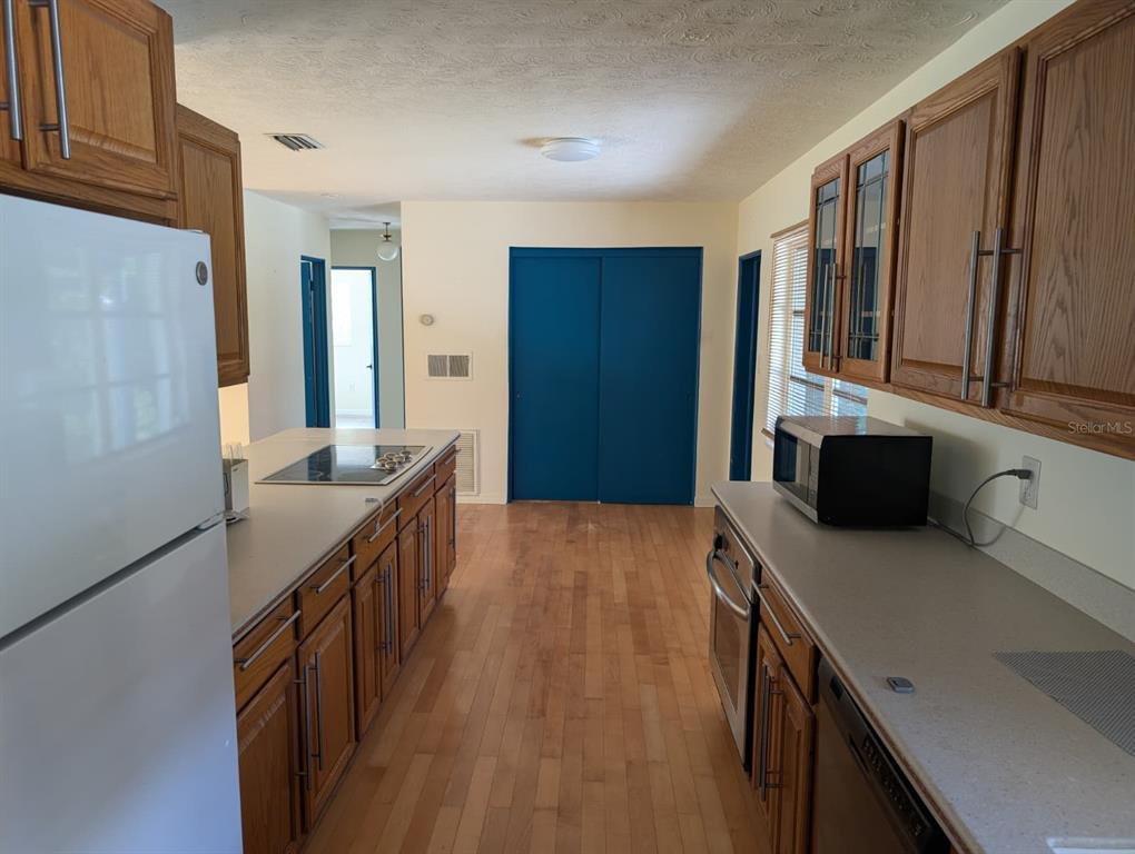 1176 40th Street Sarasota, FL 34234 - Photo 12 of 37 a kitchen with stainless steel appliances a stove cabinets and wooden floor
