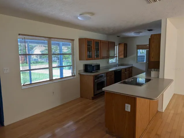 a kitchen with stainless steel appliances granite countertop a sink stove and a refrigerator