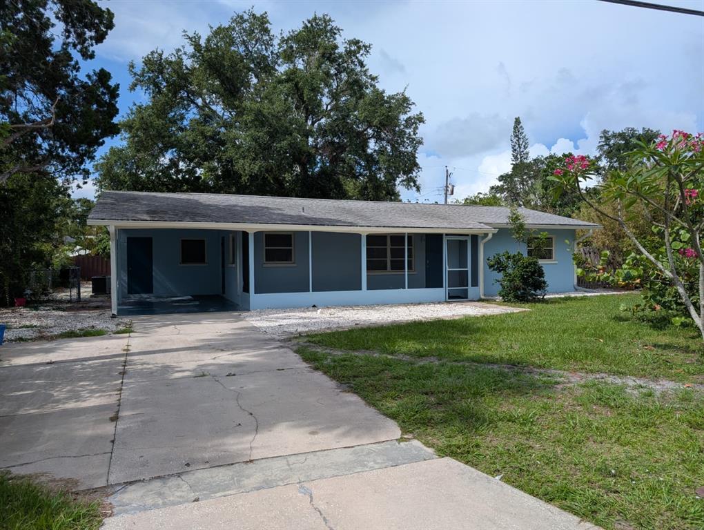 1176 40th Street Sarasota, FL 34234 - Photo 2 of 37 front view of a house with a yard