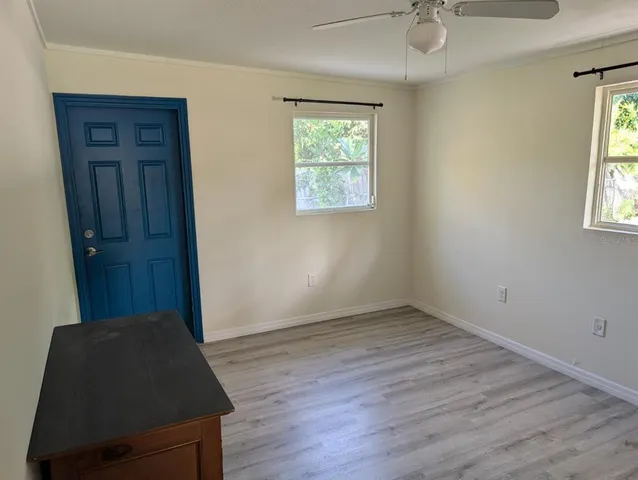 an empty room with windows and closet