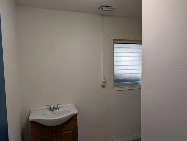 a bathroom with a sink and a window