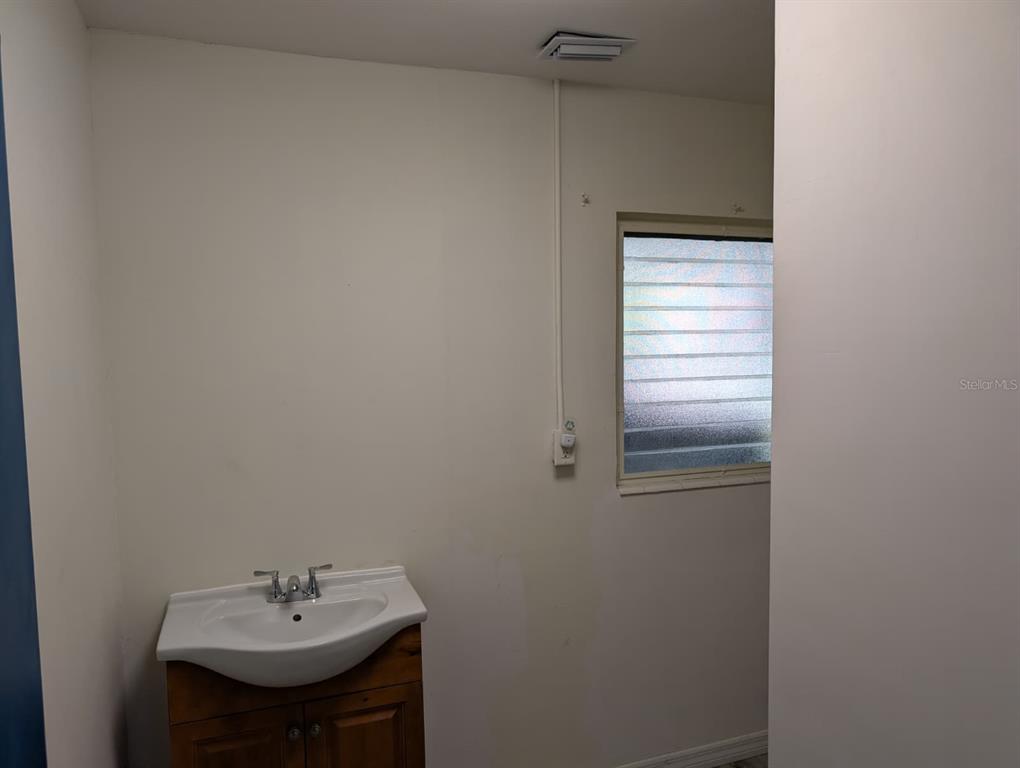 1176 40th Street Sarasota, FL 34234 - Photo 24 of 37 a bathroom with a sink and a window