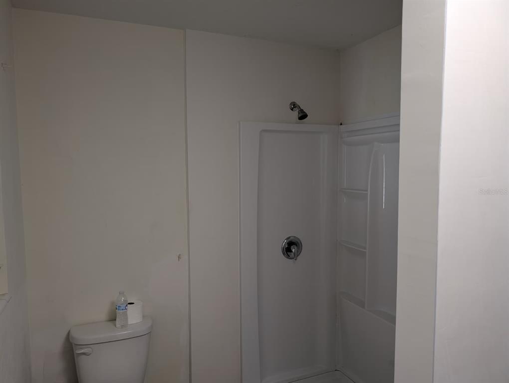 1176 40th Street Sarasota, FL 34234 - Photo 26 of 37 a bathroom with a toilet and sink