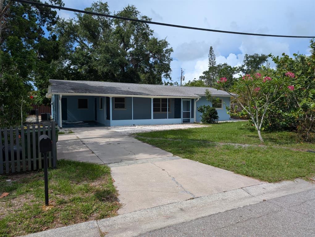 1176 40th Street Sarasota, FL 34234 - Photo 6 of 37 a front view of a house with a garden and plants