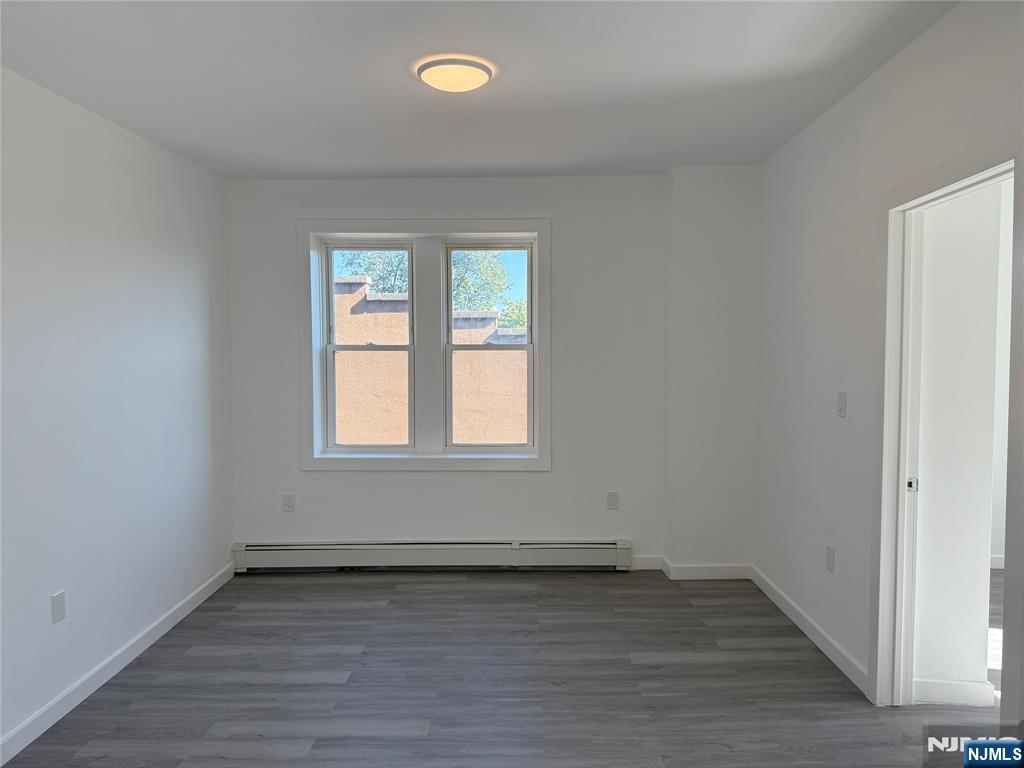 610 Gregory Avenue, Unit 2 Weehawken, NJ 07086 - Photo 12 of 18 an empty room with wooden floor and windows
