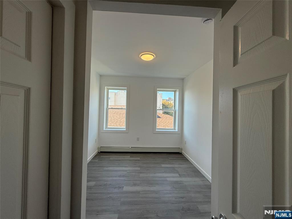 610 Gregory Avenue, Unit 2 Weehawken, NJ 07086 - Photo 15 of 18 a view of empty room with wooden floor and fan