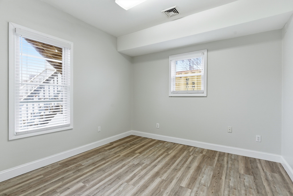 545 Brayton Avenue Fall River, MA 02721 - Photo 11 of 16 a view of an empty room with wooden floor and a window