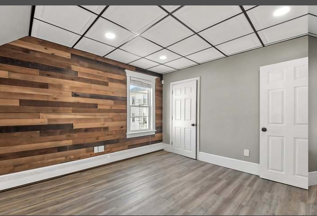 545 Brayton Avenue Fall River, MA 02721 - Photo 12 of 16 a view of empty room with wooden floor and fan