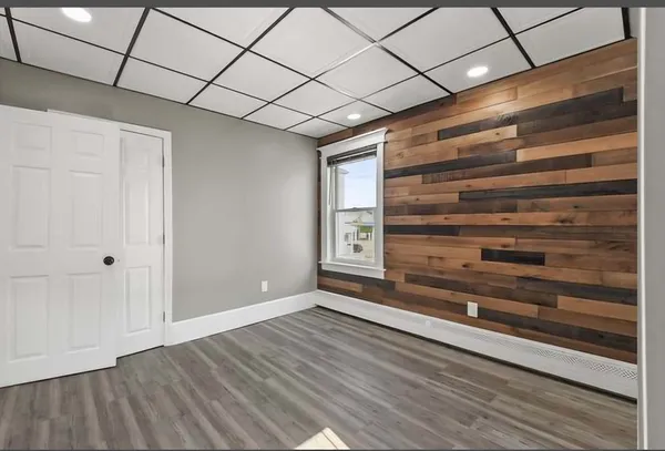 a view of an empty room and wooden floor
