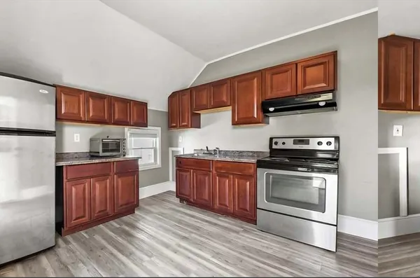 a kitchen with stainless steel appliances granite countertop a stove microwave and sink