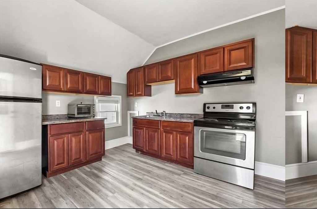 545 Brayton Avenue Fall River, MA 02721 - Photo 14 of 16 a kitchen with stainless steel appliances granite countertop a stove microwave and sink
