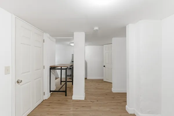 a view of a hallway with wooden floor