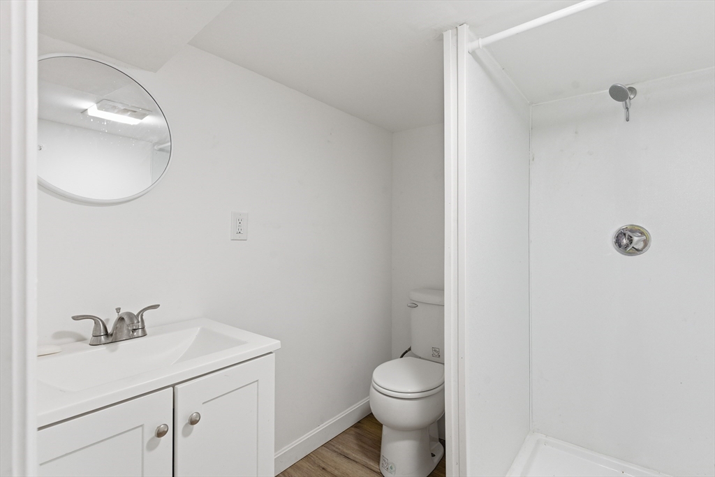 545 Brayton Avenue Fall River, MA 02721 - Photo 16 of 16 a bathroom with a toilet a sink and mirror