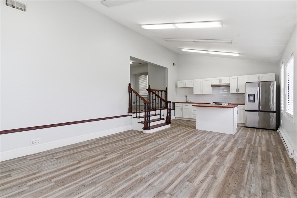 545 Brayton Avenue Fall River, MA 02721 - Photo 4 of 16 a view of a kitchen with wooden floor and electronic appliances