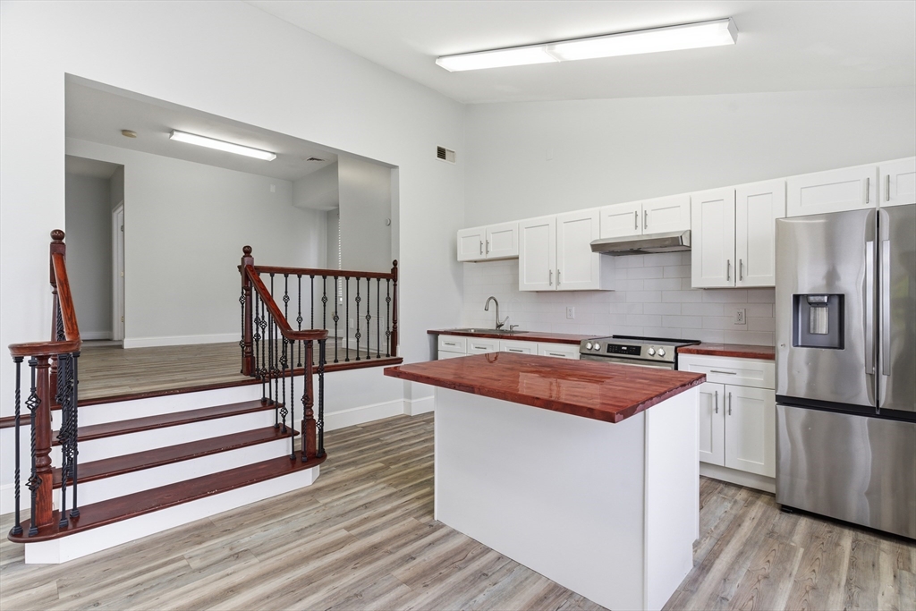 545 Brayton Avenue Fall River, MA 02721 - Photo 5 of 16 a kitchen with stainless steel appliances granite countertop a sink stove and refrigerator