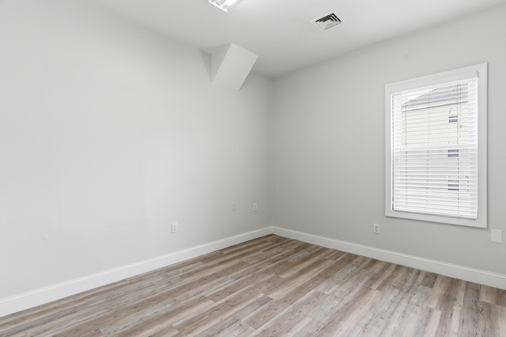 545 Brayton Avenue Fall River, MA 02721 - Photo 8 of 16 a view of empty room with wooden floor and fan