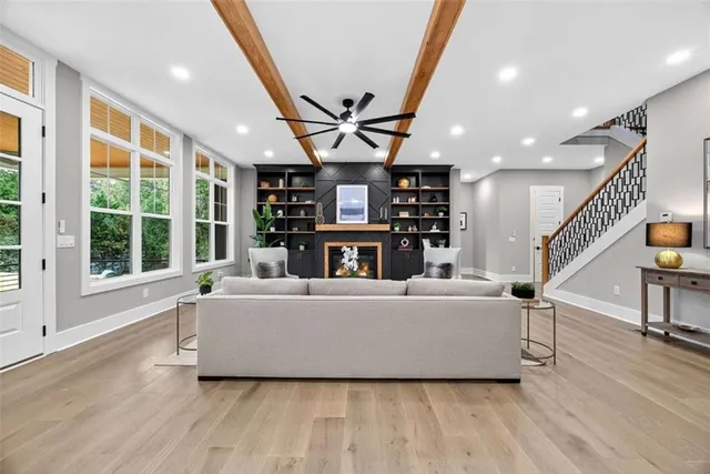 a large white kitchen with lots of counter space and stainless steel appliances