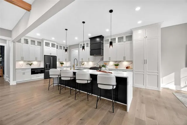 a bathroom with a granite countertop sink a toilet and shower