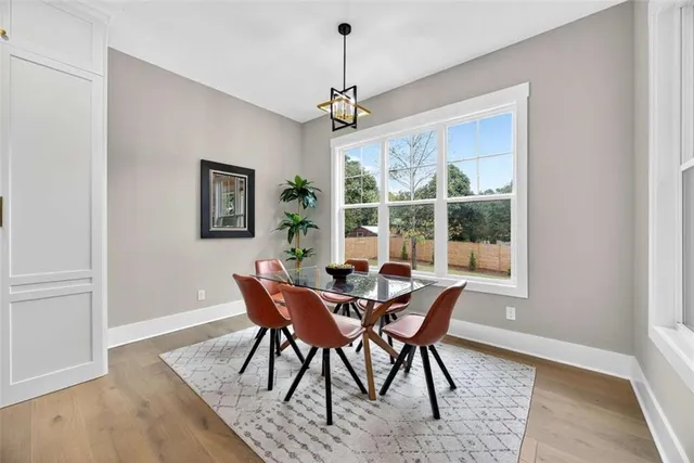 a bathroom with a granite countertop sink a toilet and a mirror