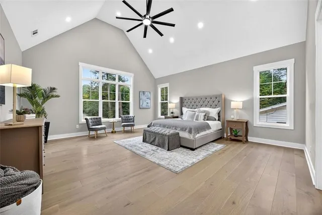 an empty room with windows and chandelier fan