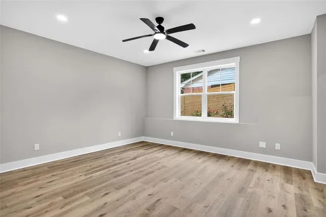 an aerial view of a house with swimming pool and large trees