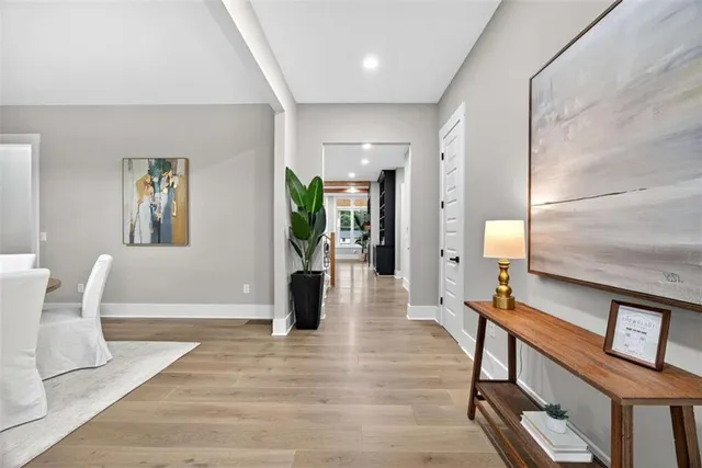 a living room with furniture a large window and gym equipment