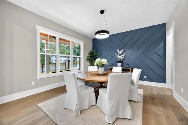 a living room with fireplace furniture and a large window