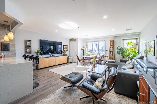 a living room with furniture or kitchen view and a wooden floor