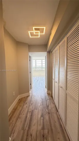 a view of hallway with wooden floor