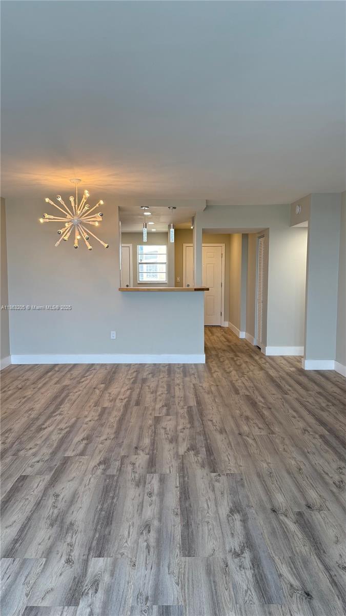1750 Northeast 191st Street, Unit 7254 Miami, FL 33179 - Photo 4 of 16 a view of a room with wooden floor and window
