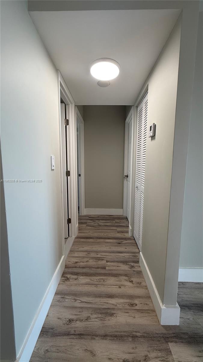 1750 Northeast 191st Street, Unit 7254 Miami, FL 33179 - Photo 8 of 16 a view of a hallway with wooden floor and closet