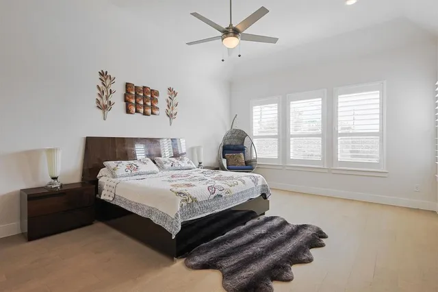 a bedroom with a bed dresser and a window