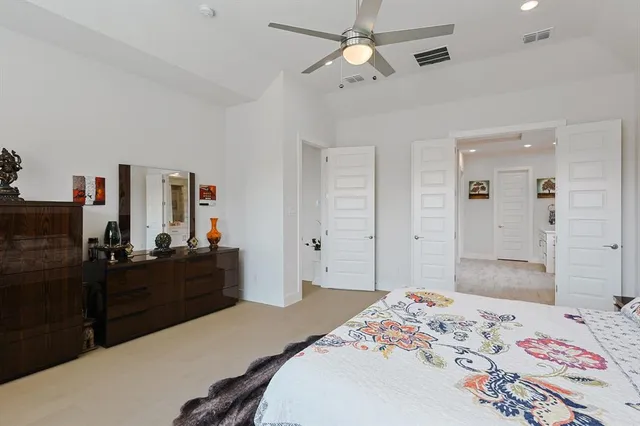 a bedroom with a bed and a dresser