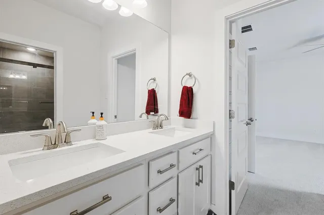 a bathroom with a double vanity sink mirror and double
