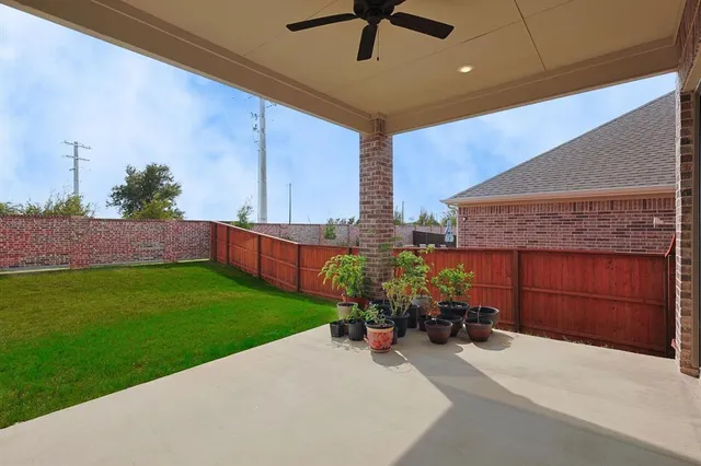 a view of a patio with a table and chairs