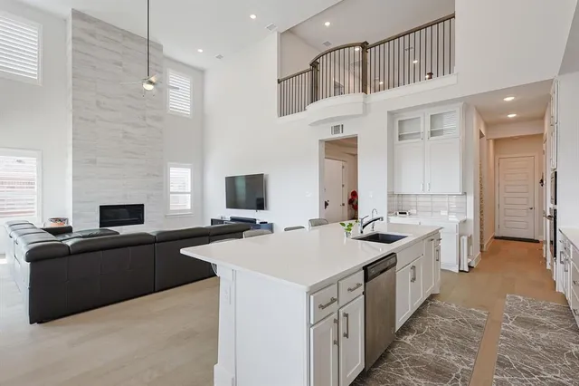 a kitchen that has a sink and a stove in it