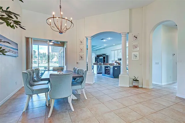 a kitchen with stainless steel appliances granite countertop a refrigerator stove and white cabinets