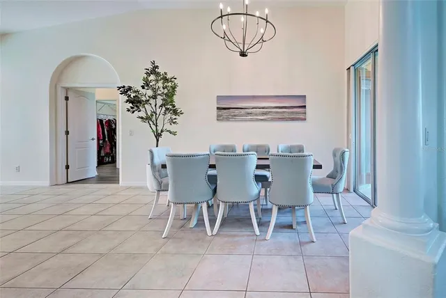 a dining room with furniture and a potted plant