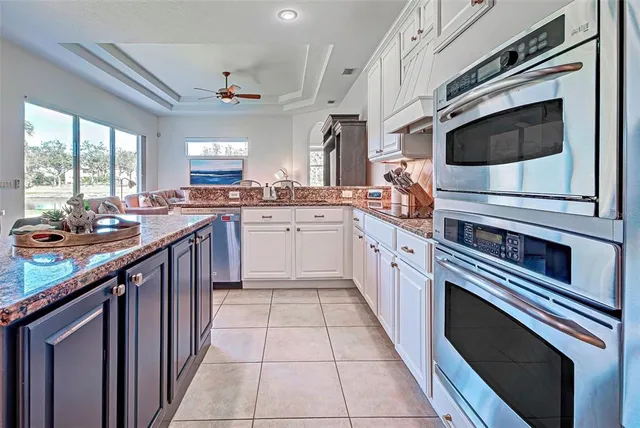 a kitchen with stainless steel appliances a stove a sink a refrigerator and cabinets