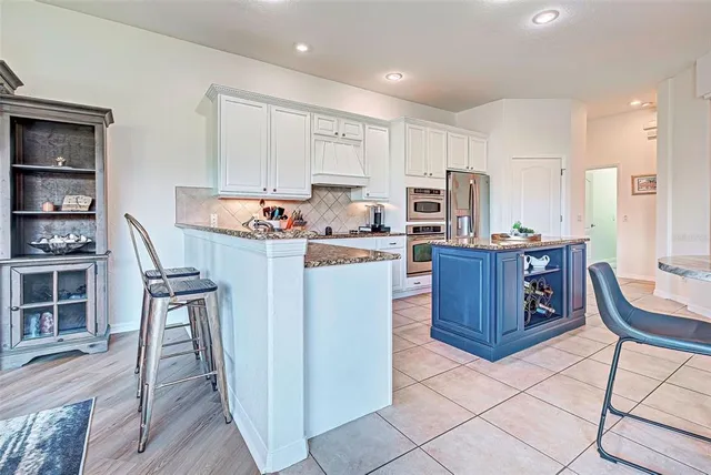 a dining room with furniture water view and a floor to ceiling window